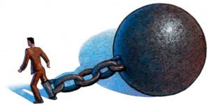 Large ball and chain attached to man's leg